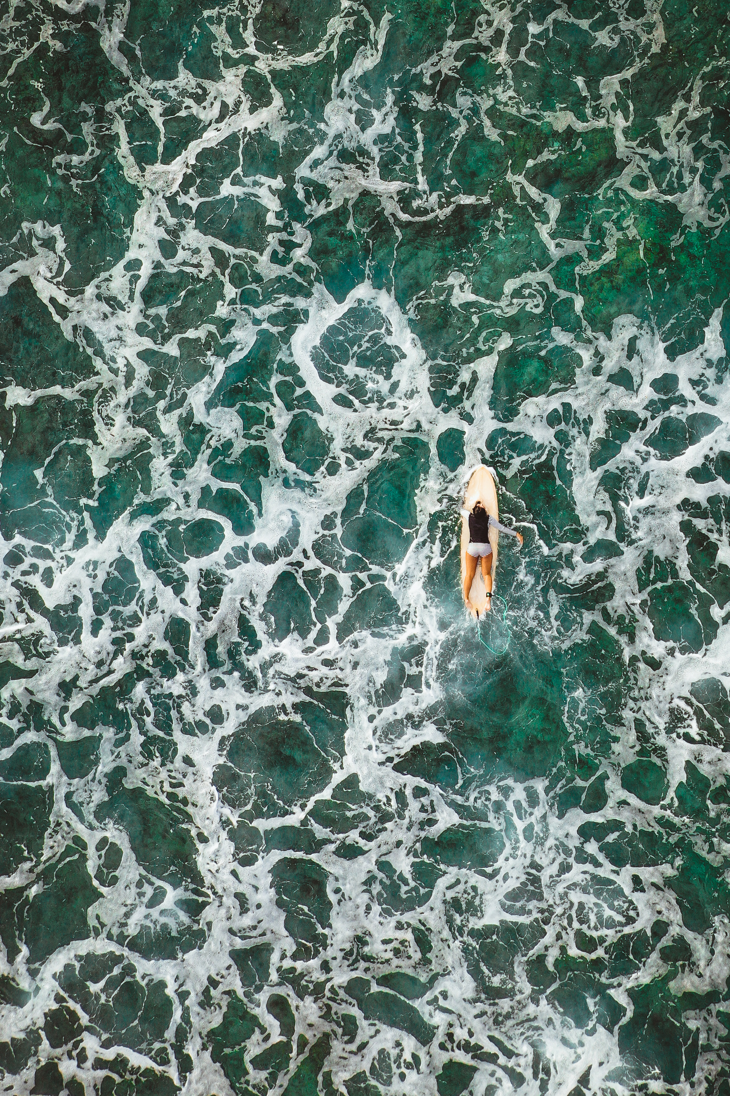 surfing woman from drone